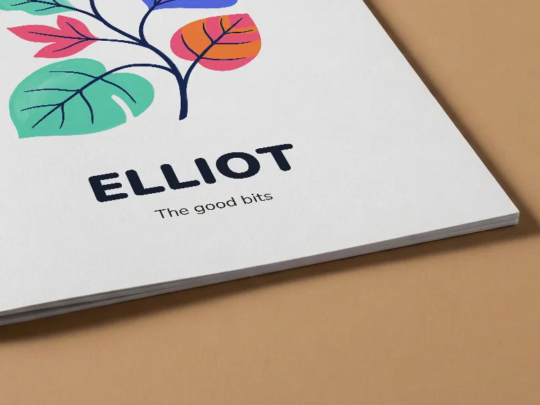 Close-up of a colouring book cover with the name Elliot, on tan card, showing the cover card and its thin page edge.